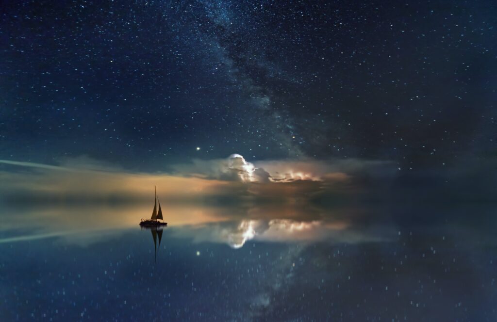 A sailboat that seems to be floating on the stars and clouds of eternity. That will be a very long trip indeed.
