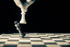 Chess's white king knocks over enemy king