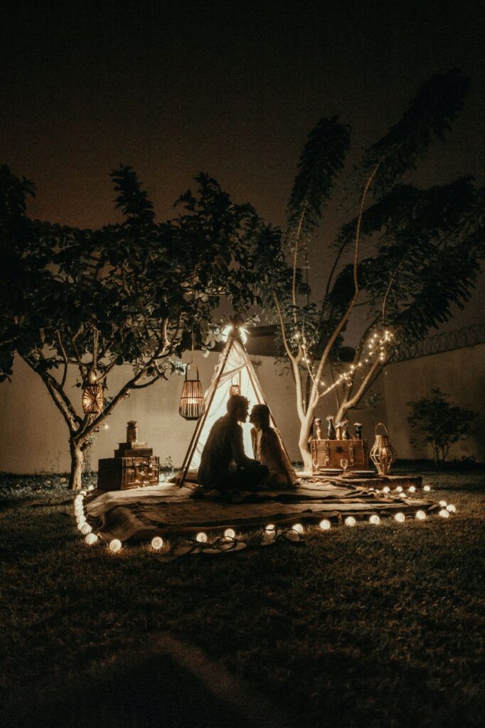 A romantic set up with lights and a couple kissing