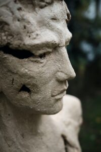 Statue of a hero with a crumbling face