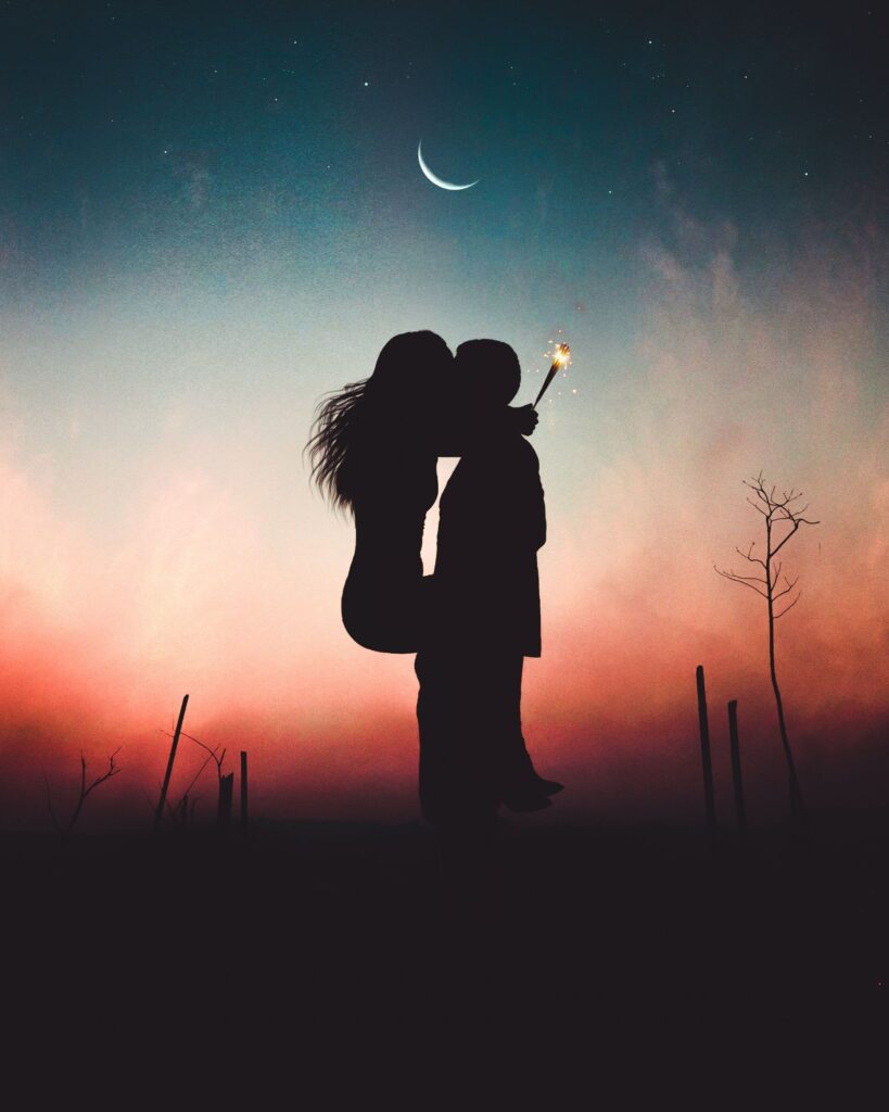 silhouette of two lovers with moon and colors in background